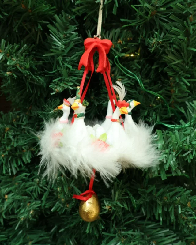 Gänsen-Krinkle "12 Days 6 Geese Ornament" von Patience Brewster hängen am Tannenbaum. Zu sehen sind 6 weiße Gänsen welche zusammen an einer Schleife hängen.