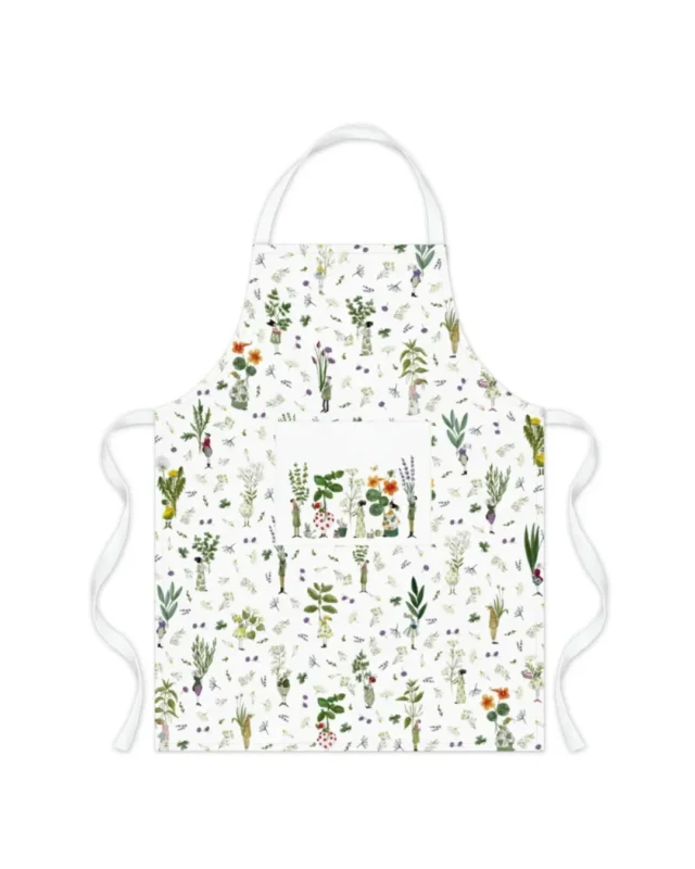 Kochschürze „Kräutergarten“ vom Grätz Verlag mit hellem Kräuter-Allover-Muster und zentraler Tasche, illustriert von Silke Leffler.