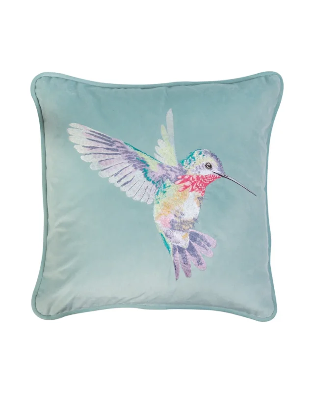 Türkises Kissen aus Samt mit aufgesticktem Kolibri-Motiv Wisteria von Wrendale Designs auf weißem Hintergrund.