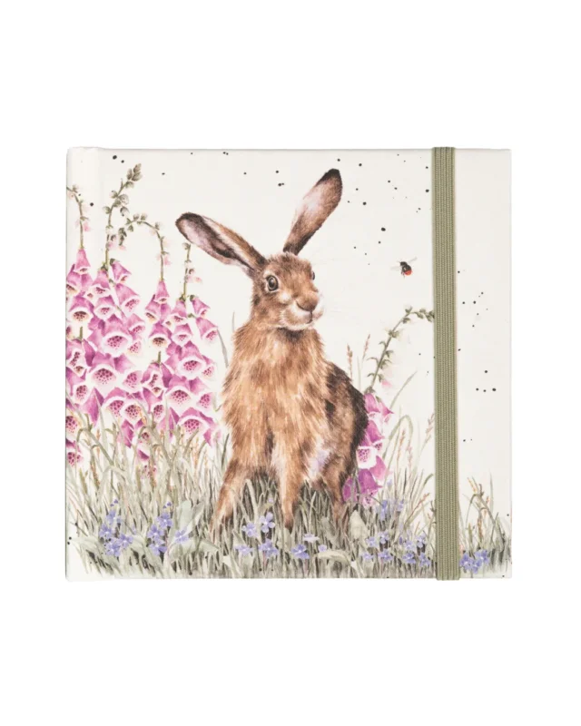 Das Cover des Mini Hasen Notizbuchs zeigt einen braunen Hasen, welcher aufmerksam in einer Blumenwiese sitzt. Veilchen und Fingerhut werden von einer Hummel angeflogen. Das Design von Hannah Dale ist typischerweise sehr liebevoll und detailreich gestaltet.