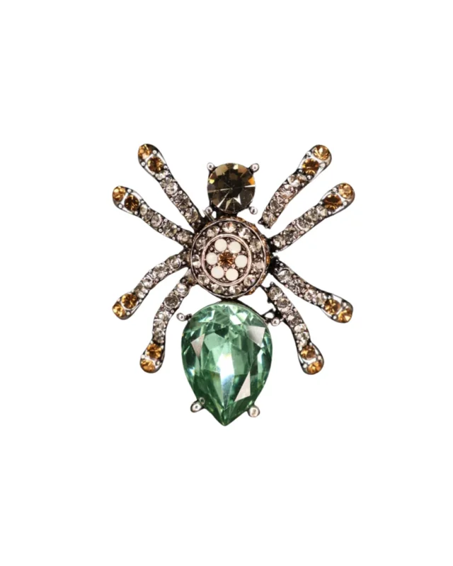 Mit Glitzersteinen verzierte Vorderseite der Spinnen Brosche "Elegant Spider" von Giuno vor weißen Hintergrund.