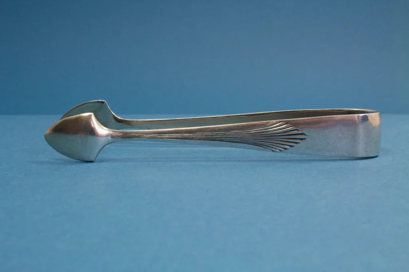 Silver plated sugar tongs with art deco pattern